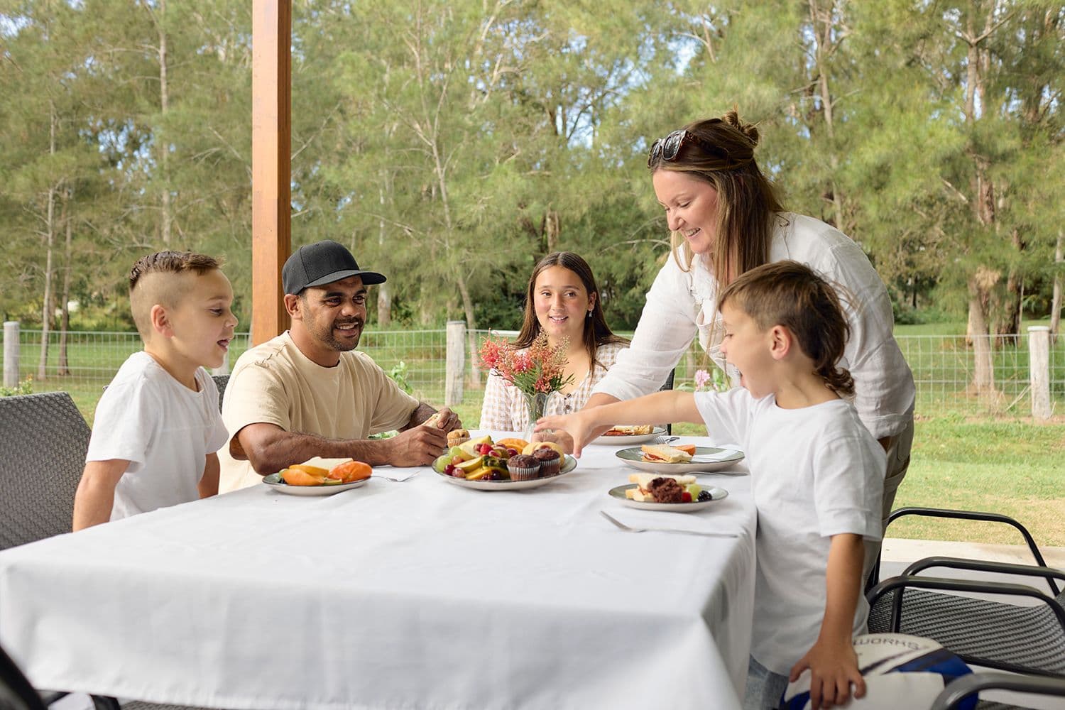 Bonus Reward Saver - Family eating a mean around a table.